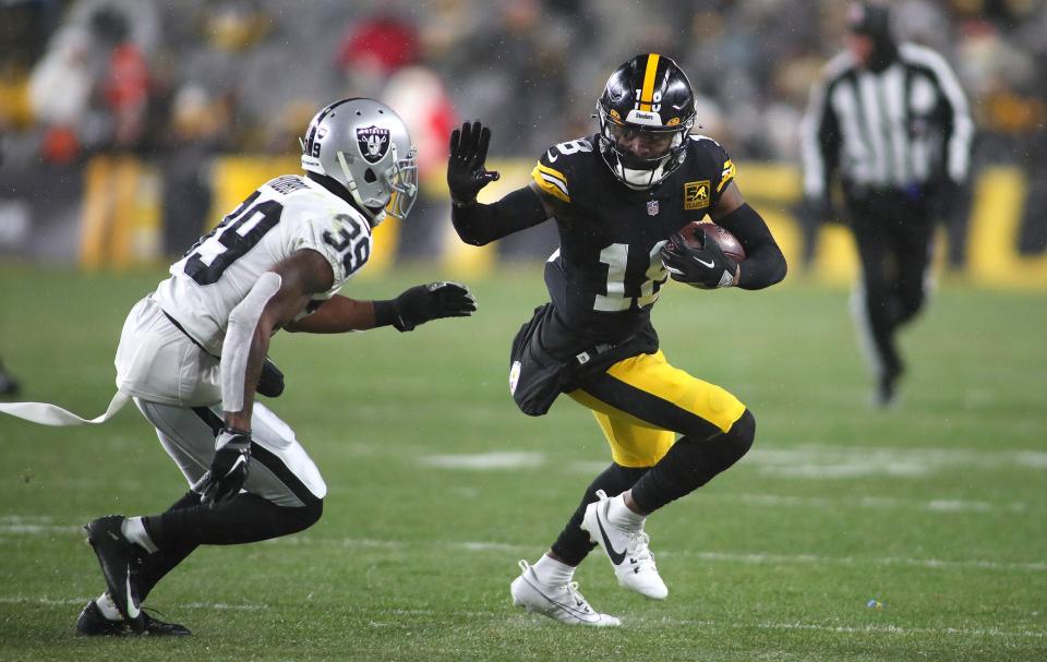 Pittsburgh Steelers Diontae Johnson (18) stiff arms <a class="link " href="https://sports.yahoo.com/nfl/teams/las-vegas/" data-i13n="sec:content-canvas;subsec:anchor_text;elm:context_link" data-ylk="slk:Las Vegas Raiders;sec:content-canvas;subsec:anchor_text;elm:context_link;itc:0">Las Vegas Raiders</a> <a class="link " href="https://sports.yahoo.com/nfl/players/33555" data-i13n="sec:content-canvas;subsec:anchor_text;elm:context_link" data-ylk="slk:Nate Hobbs;sec:content-canvas;subsec:anchor_text;elm:context_link;itc:0">Nate Hobbs</a> (39) during the first half at Acrisure Stadium in Pittsburgh, PA on December 24, 2022. (Michael Longo / USA TODAY NETWORK)