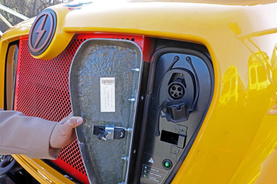 Director of Transportation Elizaœl D’az shows the charging port of the new electric bus that the Tarrytowns school district got this year, at the bus depot in Sleepy Hollow Dec. 21, 2023.