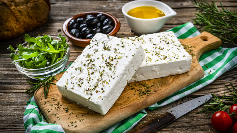 Feta cheese with herbs on board