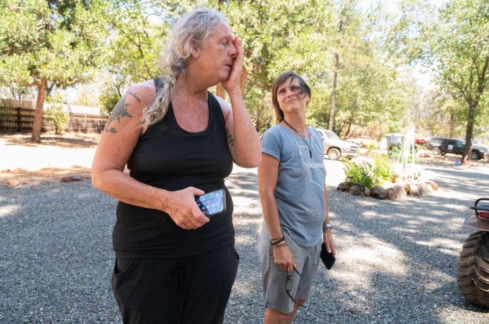 Kristi Lopez, left, and Mariana Stefanic stand outside their home in Cohasset on Friday, July 26, 2024. Their fence burned but their house sustained minimal damage during the Park Fire, and Lopez said she opened her property to residents who needed help during last night’s mandatory evacuation.