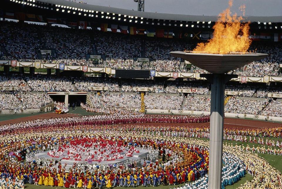 <p>The last, as of now, opening ceremony to take place during the daytime featured skydivers and even a mass demonstration of taekwondo. The ceremony is best known, unfortunately, for the peace doves that came to rest on the cauldron as it was lit.</p>