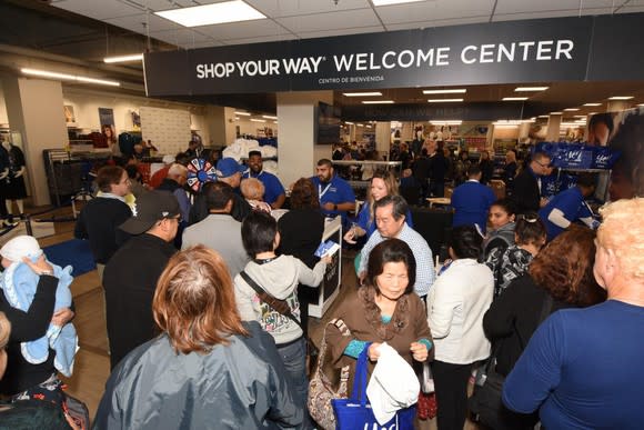 Customers crowd a welcome center at a Sears store
