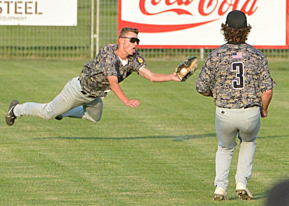 Aberdeen Smittys leftfielder Cooper Eisenbeisz makes a diving catch in front of teammate Phillip Zens during Game 1 of a best-of-three American Legion Baseball regional playoff series against Watertown Post 17 on Thursday, July 20, 2023 at Watertown Stadium. Aberdeen won 15-4.