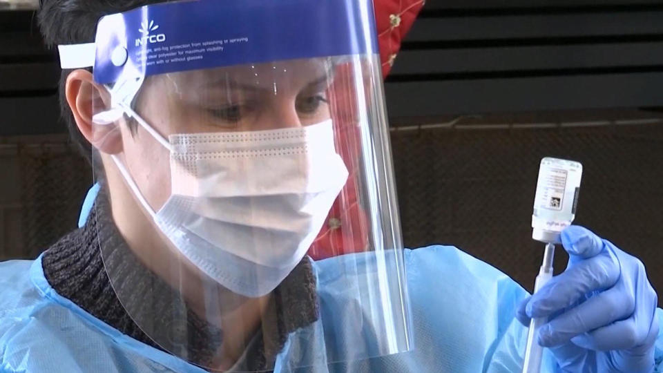 A healthcare worker prepares to administer the COVID-19 vaccine. / Credit: CBS News