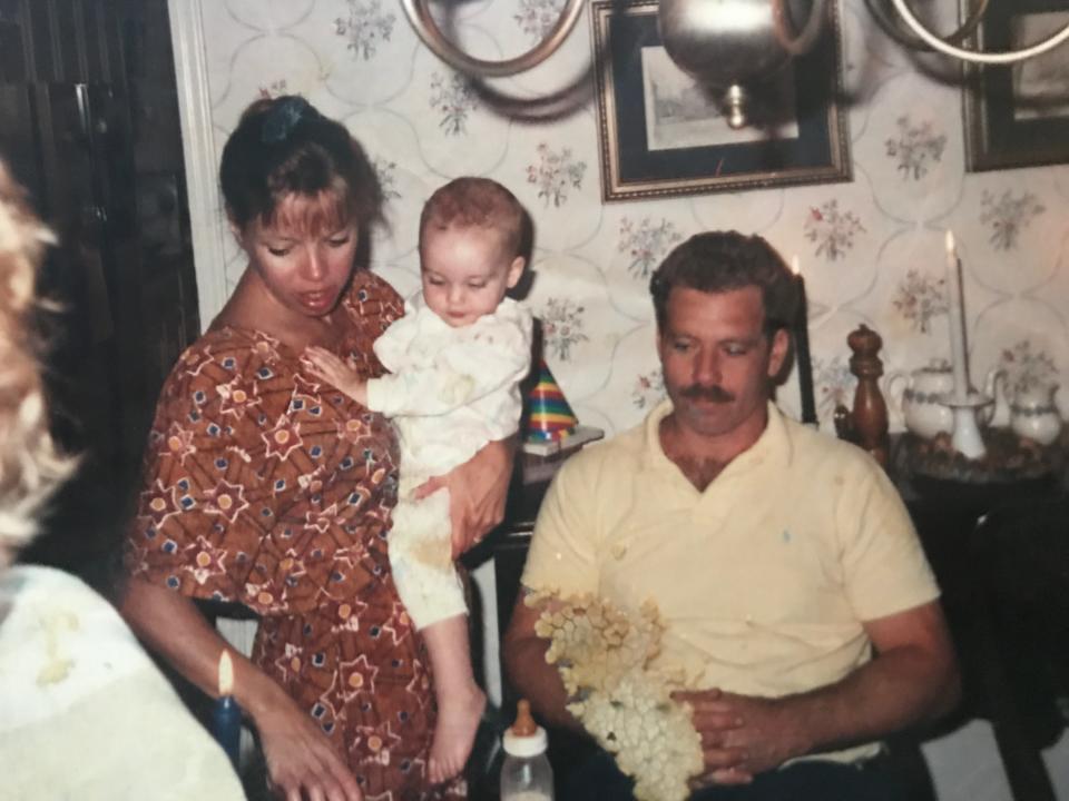 Young parents holding baby family photo