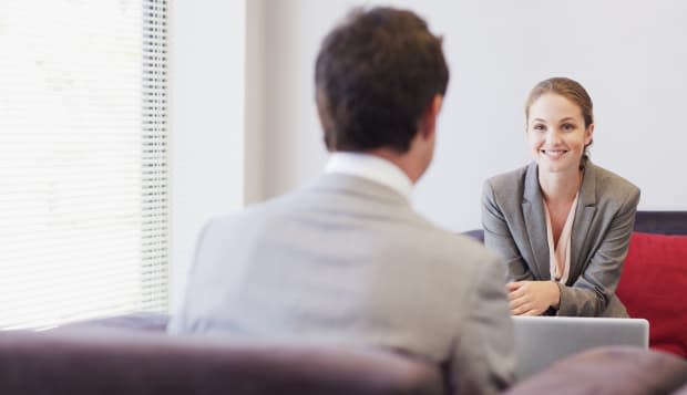 Business people talking face to face in lobby