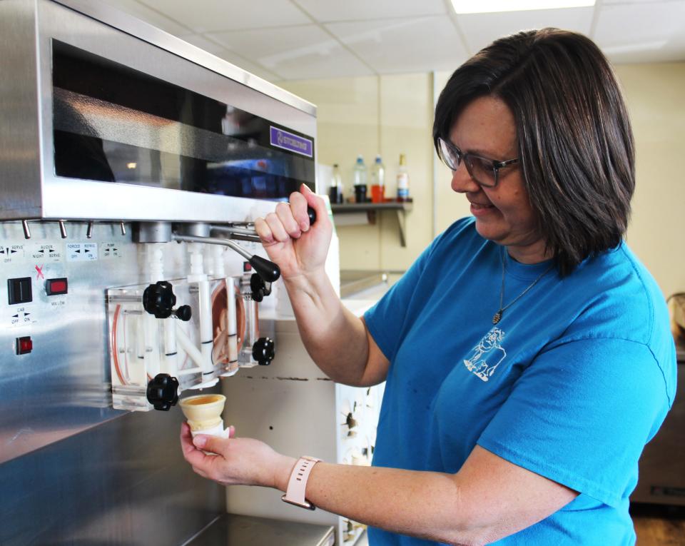 Missi May, owner of the Dairy Bar Restaurant in Berlin, makes a soft-serve ice cream cone for a customer. What was once known as Glessner's Dairy Bar was famous for their ice cream in year's past.