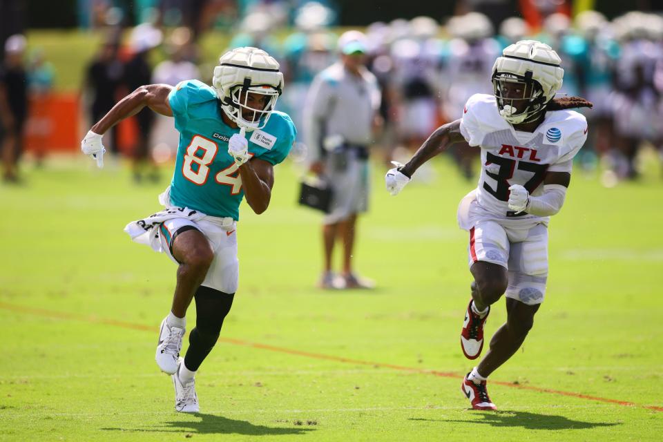 Aug 6, 2024; Miami Gardens, FL, USA; Miami Dolphins wide receiver Anthony Schwartz (84) runs against Atlanta Falcons cornerback Harrison Hand (37) during a joint practice at Baptist Health Training Complex. Mandatory Credit: Sam Navarro-USA TODAY Sports