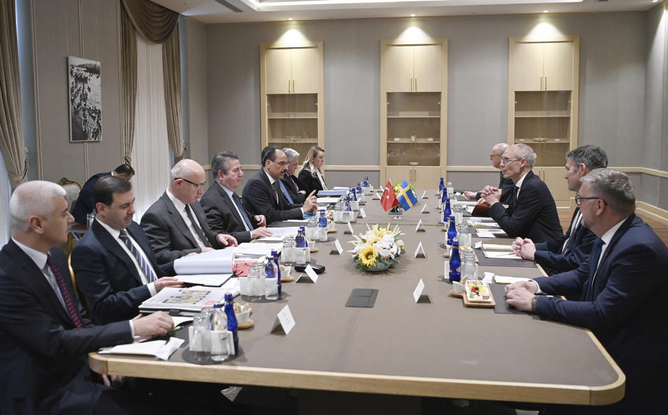 Ibrahim Kalin, the spokesman of President Recep Tayyip Erdogan, fifth from left, and Turkish delegation, left, speak with Swedish delegation headed by State Secretary Oscar Stenstroem, third right, in Ankara, Turkey, Wednesday, May 25, 2022. Senior officials from Sweden and Finland met with Turkish counterparts in Ankara on Wednesday in an effort to overcome Turkey's strong objections to the Nordic nations' bids to join NATO. Sweden and Finland submitted their written applications to join NATO last week.(Turkish Presidency via AP)