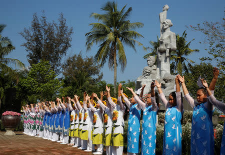 Schoolgirls perform during the 50th anniversary of the My Lai massacre in My Lai village, Vietnam March 16, 2018. REUTERS/Kham