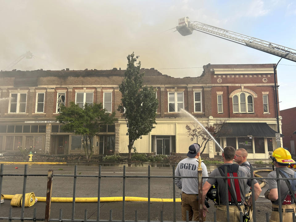 Members of the Bowling Green Fire Department work to extinguish an early morning structure fire on State Street Friday, July 21, 2023 in Bowling Green, Ky. The building, home to Senator Rand Paul's Bowling Green local office, sustained heavy damage, including a roof collapse. (Jake Moore/Daily News via AP)