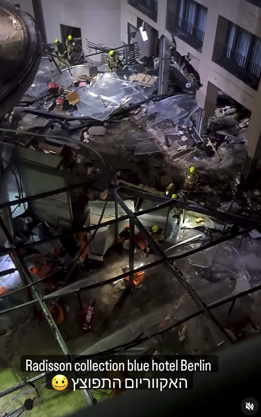 Following the burst of a huge aquarium, the atrium of a hotel is devastated in Berlin Germany, Friday, Dec. 16, 2022. German police say a huge aquarium in the center of Berlin has burst, causing a wave of devastation in and around the Sea Life tourist attraction. The words in Hebrew reads: 'The Aquarium exploded'. (instagram/tnn/dpa via AP)