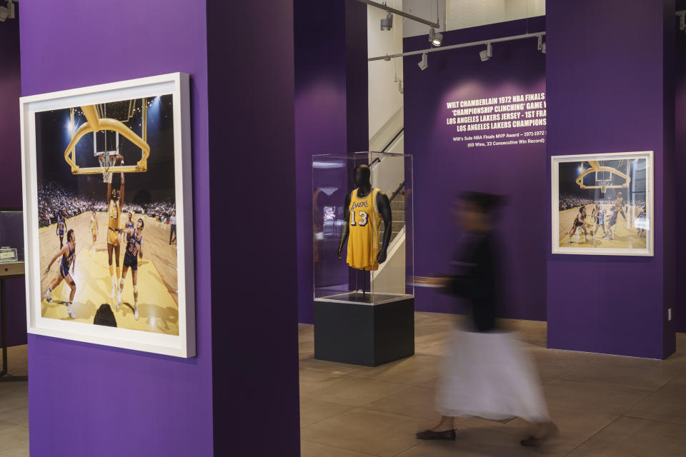 Wilt Chamberlain's 1972 NBA Finals 'Championship Clinching' Jersey, from the first ever championship for the Los Angeles Lakers, center, is previewed at Sotheby's Los Angeles Gallery on Tuesday, Aug. 1, 2023, in Beverly Hills, Calif. The jersey is being offered along with a collection of memorabilia in an online sale Aug. 28-Sept. 27. (AP Photo/Damian Dovarganes)