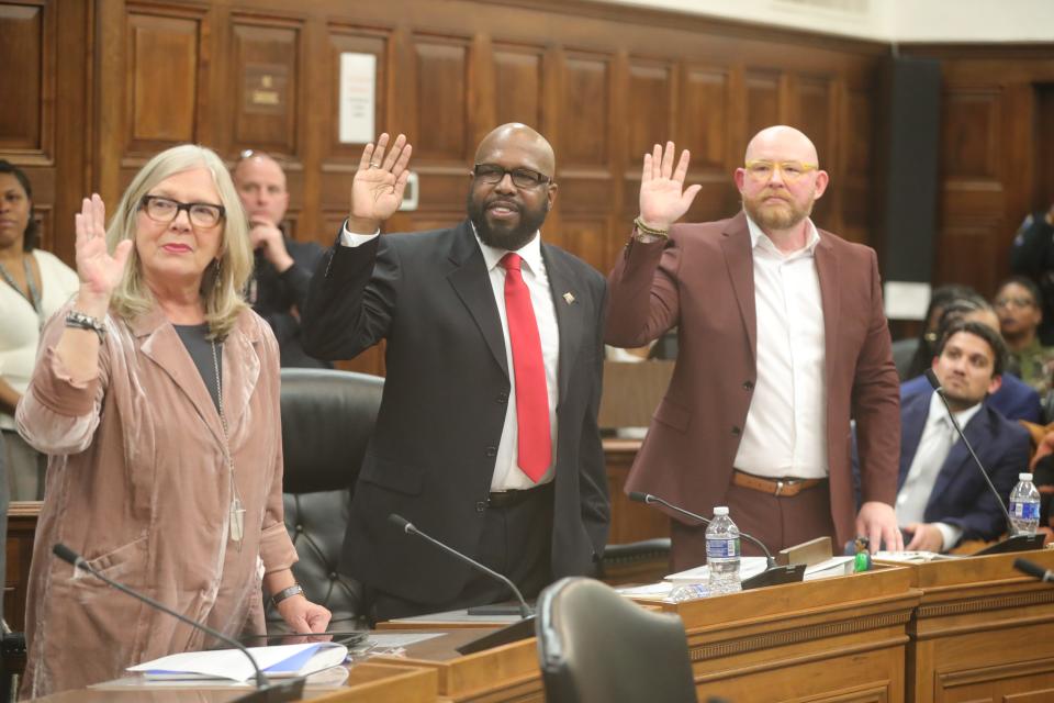 Akron City Council members Nancy Holland, Eric Garrett, and James Hardy are sworn in Monday by Judge Kani Hightower.