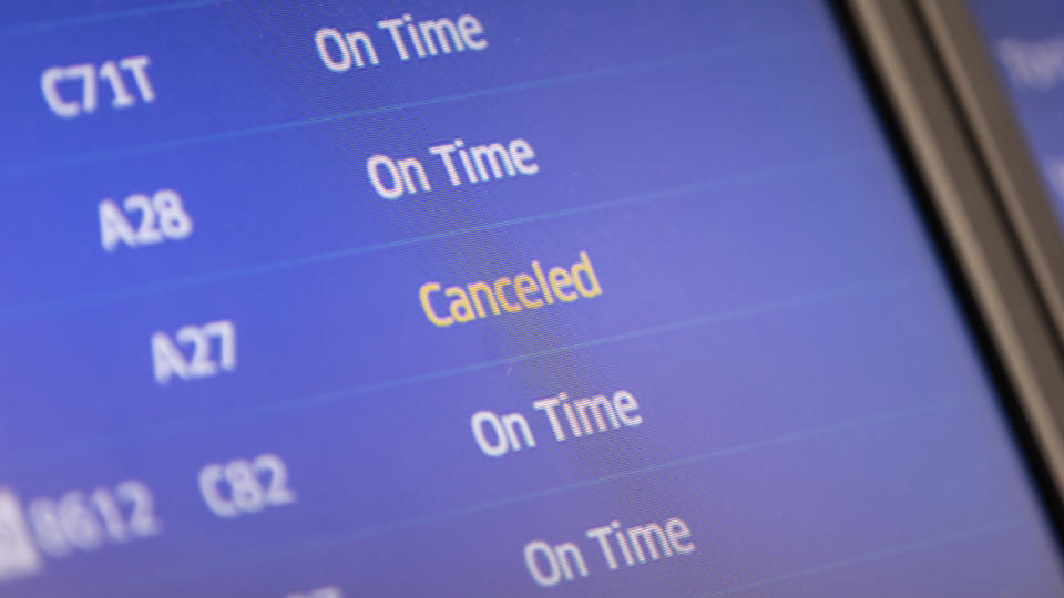 A canceled flight on a departures board at Newark Liberty International Airport.