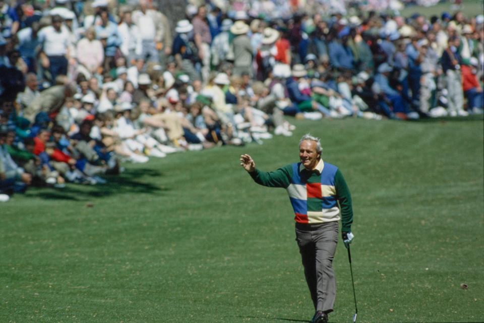 Arnold Palmer walks on the fairway and acknowledges spectators at the Augusta National Golf Course during the 1984 Masters.