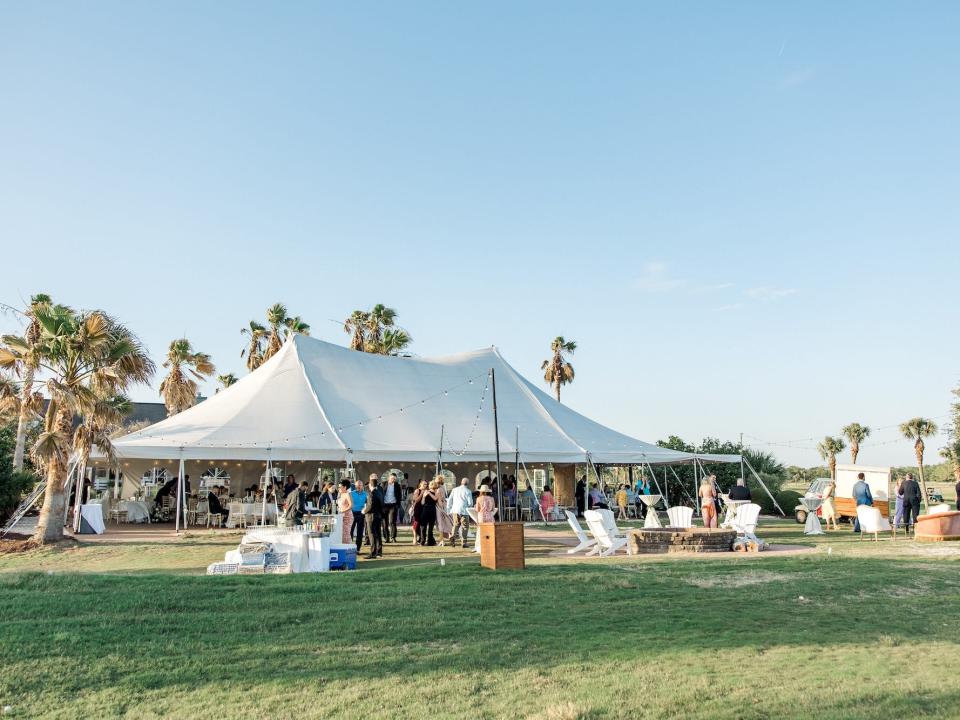 A tent for a wedding sits in front of a blue sky.