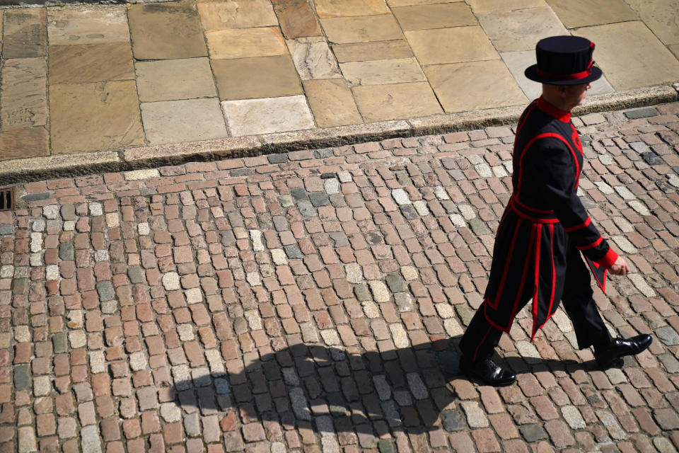 <p>A Yeoman Warder walks through the Tower Of London as the first Yeoman Warder led tour of the tower in 16 months takes place after the final legal Coronavirus restrictions were lifted in England. Picture date: Monday July 19, 2021.</p>
