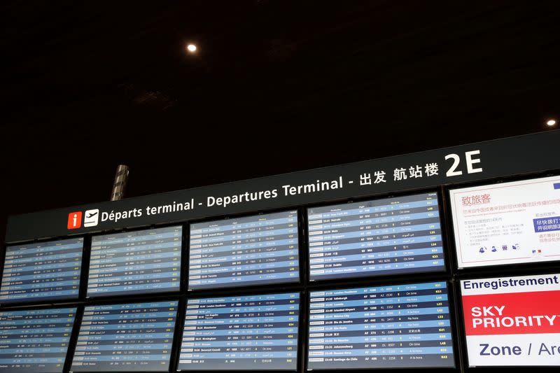 Screens display flight information inside Terminal 2E at Paris Charles de Gaulle airport