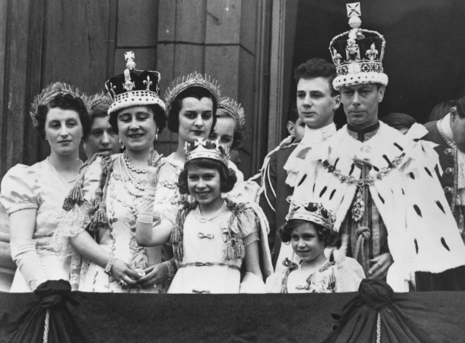 <p>King George VI and Queen Elizabeth with Princesses Elizabeth and Margaret dressed in full Coronation regalia on the balcony of Buckingham Palace after the King's 1937 Coronation ceremony.</p>