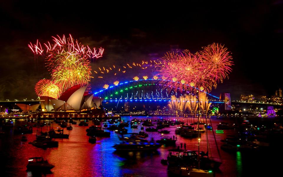 Fireworks explode over the Sydney Harbour Bridge and Sydney Opera House