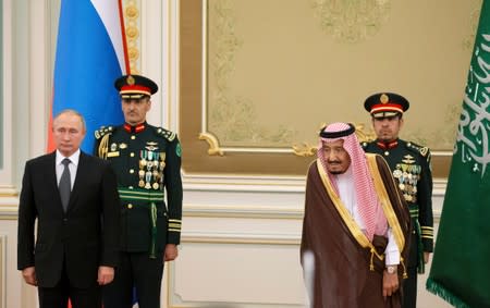 Russian President Vladimir Putin and Saudi Arabia's King Salman attend the official welcome ceremony in Riyadh