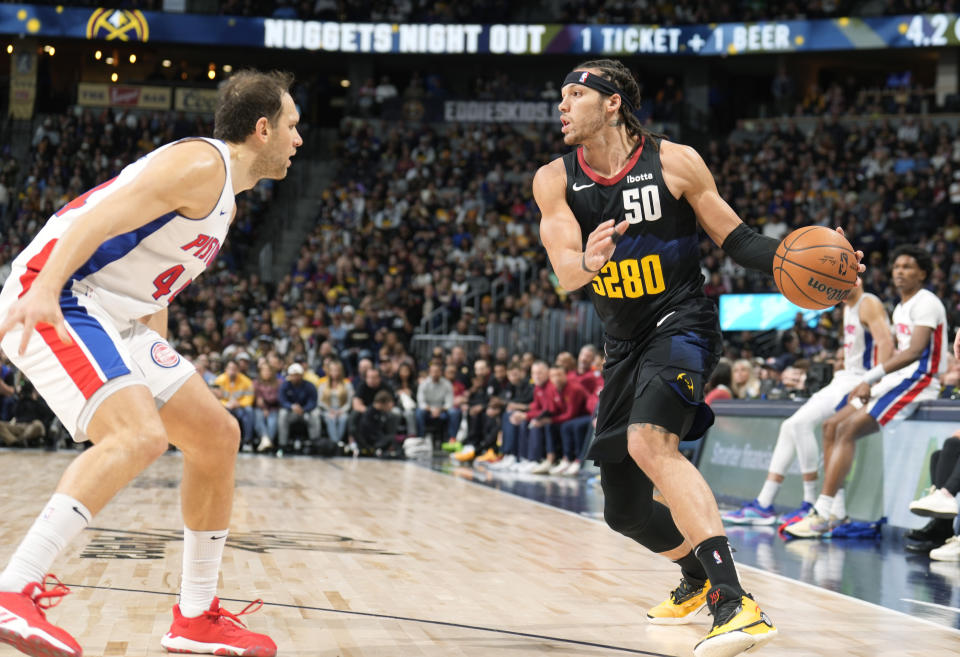 Denver Nuggets forward Aaron Gordon, right, looks to drive to the basket as Detroit Pistons forward Bojan Bogdanovic, left, defends in the first half of an NBA basketball game Sunday, Jan. 7, 2024, in Denver. (AP Photo/David Zalubowski)