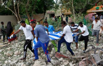 <p>Somali men carry away the body of a civilian who was killed in a militant attack on a restaurant in Mogadishu, Somalia Thursday, June 15, 2017. (Photo: Farah Abdi Warsameh/AP) </p>