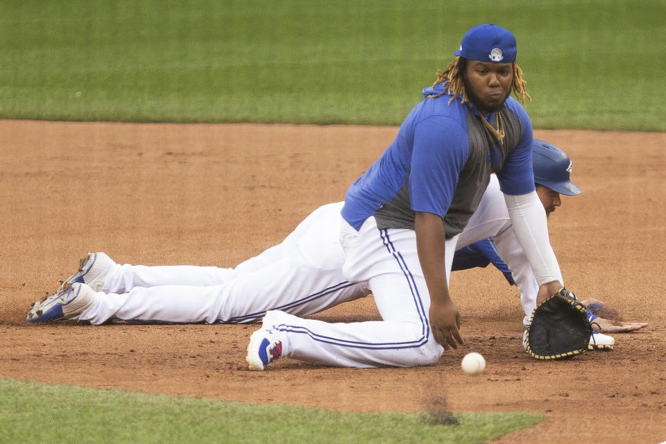 Toronto Blue Jays' Vladimir Guerrero Jr. fields a ball at first base during baseball practice in Toronto on Sunday, July 12, 2020. (Chris Young/The Canadian Press via AP)