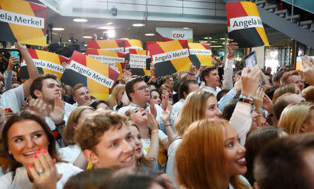 People at the Christian Democratic Union (CDU) headquarters react on first exit polls in the German general election (Bundestagswahl) in Berlin, Germany, September 24, 2017. REUTERS/Fabrizio Bensch