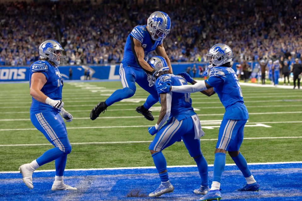 Detroit Lions running back David Montgomery (5) celebrates a touchdown with teammates against the Chicago Bears during the second half at Ford Field.
