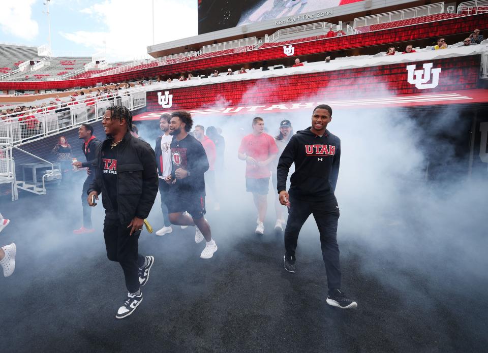 Utah Utes scholarship football players walk onto the field to celebrate getting a Dodge truck given to them by the Crimson Collective during an NIL announcement at Rice-Eccles Stadium in Salt Lake City on Wednesday, Oct. 4, 2023. | Jeffrey D. Allred, Deseret News