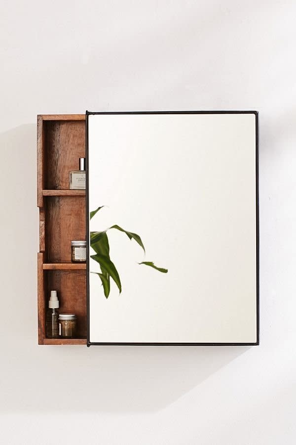 With three interior shelves, a sliding unit, and a mirror on the front, <a href="https://www.urbanoutfitters.com/shop/plymouth-sliding-storage-mirror?category=furniture&amp;color=020" target="_blank">this storage mirror</a> for under $150 is the perfect addition to your bathroom.