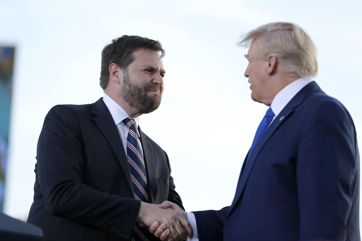 Senate candidate JD Vance, left, greets former President Donald Trump at a rally at the Delaware County Fairground, April 23, 2022, in Delaware, Ohio, to endorse Republican candidates ahead of the Ohio primary on May 3. 