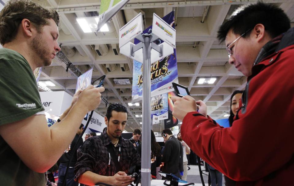 FILE - In this March 8, 2012 file photo, attendees play the Nintendo game "Mario Tennis Open" on a Nintendo 3DS console before its May release at the Game Developers Conference in San Francisco. The organizers of GDC, which kicks off Monday, March 17, 2014, at the Moscone Center in San Francisco and continues through Friday, have expanded the conference's advocacy-themed sessions with panels featuring such titles as "Beyond Graphics: Reaching the Visually Impaired Gamer," "How to Subversively Queer Your Work" and "Women Don't Want to Work in Games (and Other Myths)." (AP Photo/Paul Sakuma, file)