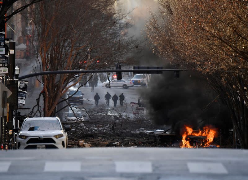 A vehicle burns near the site of an explosion in the area of Second and Commerce in Nashville