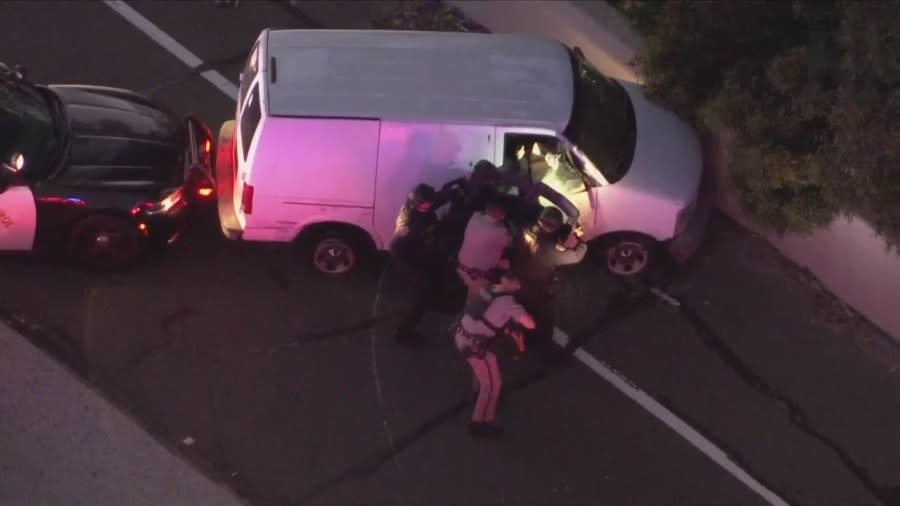 Officers approached the passenger side, preparing to remove the suspect during a standoff on the 91 Freeway on April 26, 2024. (KTLA)