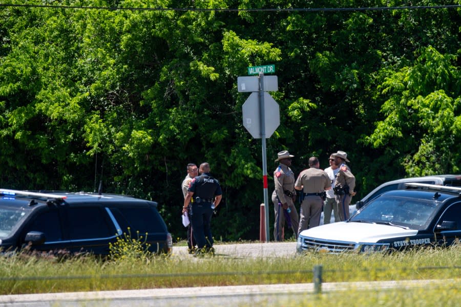 First responders on the scene after a stolen 18-wheeler crashed into a Texas Department of Public Safety office on US-290 in Brenham, Texas on Friday, April 12, 2024. The driver of a stolen semitrailer intentionally rammed it into the Texas public safety office in a rural town west of Houston on Friday, injuring multiple people, according to a state lawmaker. (Meredith Seaver /College Station Eagle via AP)