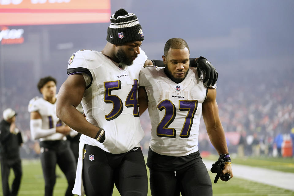 Baltimore Ravens linebacker Tyus Bowser (54) and running back J.K. Dobbins walk off the field following an NFL wild-card playoff football game against the Cincinnati Bengals in Cincinnati, Sunday, Jan. 15, 2023. The Bengals won 24-17. (AP Photo/Joshua A. Bickel)