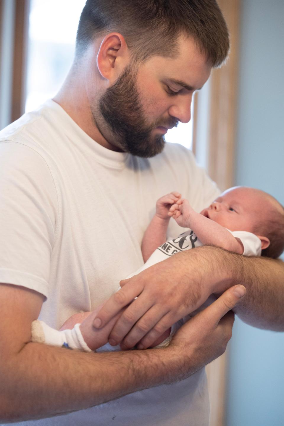 Brandon Denham holds new son, Paxton, who was born on May 27.