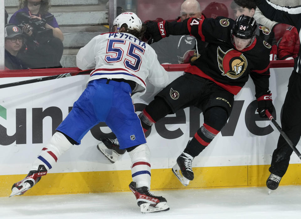 Montreal Canadiens left wing Michael Pezzetta (55) collides with Ottawa Senators defenseman Jacob Bernard-Docker (24) along the boards during first-period NHL hockey game action Thursday, Jan. 18, 2024, in Ottawa, Ontario. (Adrian Wyld/The Canadian Press via AP)