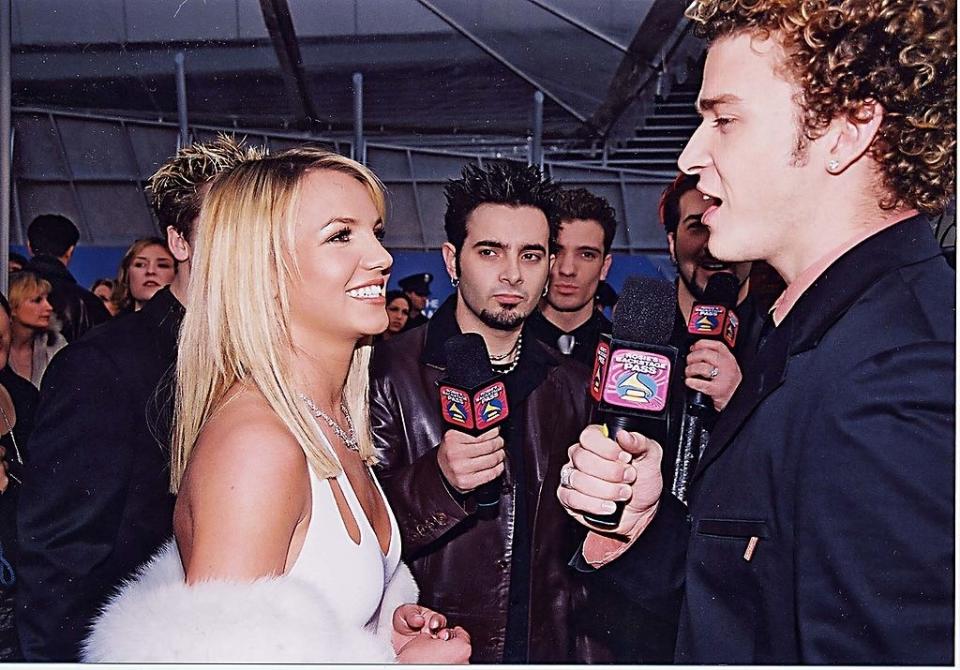 The members of NSYNC with mics talking to Britney