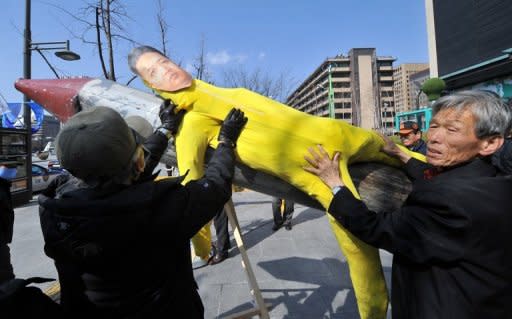 S.Korean conservative activists hang an effigy of N.Korean leader Kim Jong-Un on a mock missile, in Seoul, March 20. N.Korea held a national memorial service on Sunday to mark the 100th day since the death of leader Kim Jong-Il, hailing the country's nuclear weapons programme as his outstanding feat
