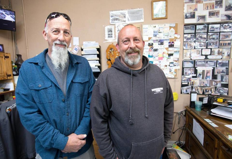 Jon Pettenger, left, and Ethan Pettenger pose for a picture in front of a wall of family photos and newspaper clippings. They worked for Scrubby & Lloyd’s restaurant in downtown San Luis Obispo, along with other family members.