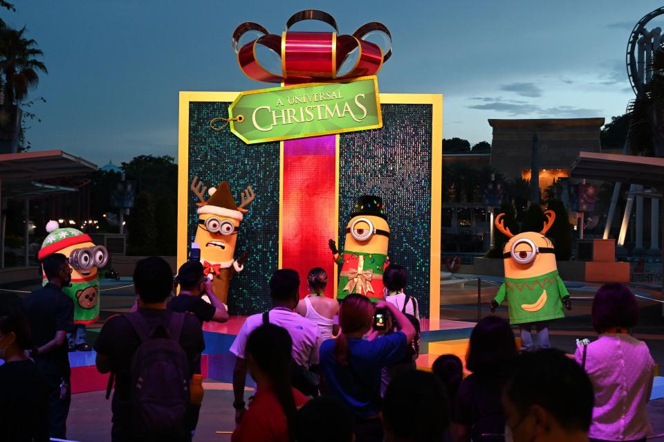 Performers dressed as Minion characters react to visitors at the Universal Studios Singapore amusement park at Resorts World Sentosa in Singapore on December 3, 2020. (Photo by ROSLAN RAHMAN / AFP) (Photo by ROSLAN RAHMAN/AFP via Getty Images)