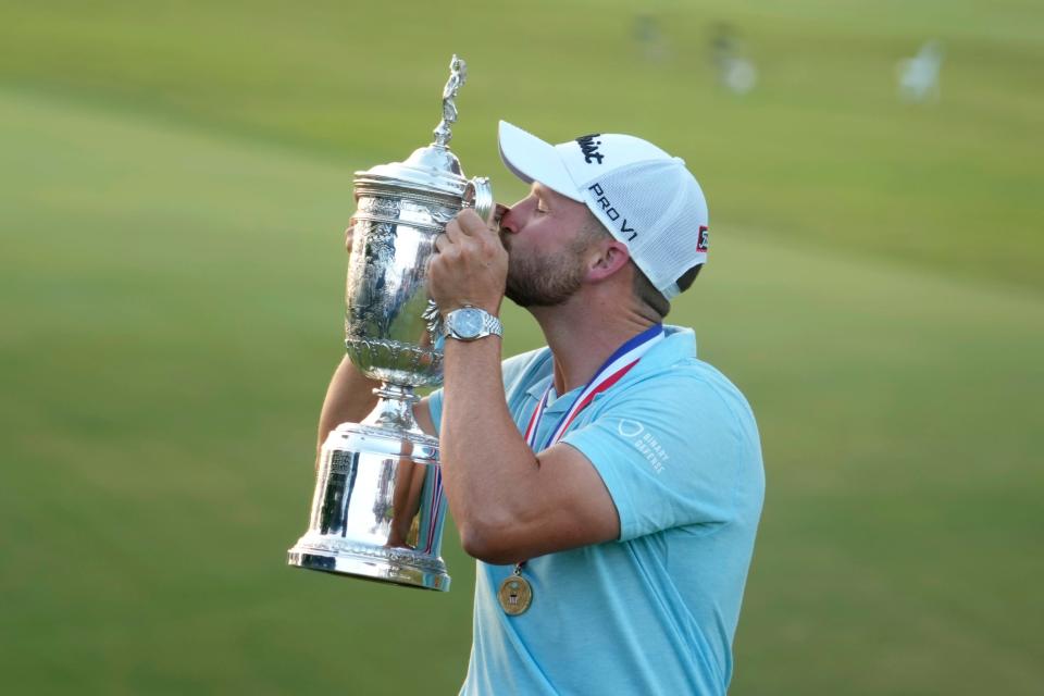 Round 4: Wyndham Clark kisses the championship trophy after winning the U.S. Open.