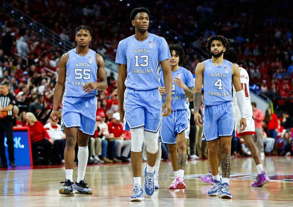 Jan 10, 2024; Raleigh, North Carolina, USA; North Carolina Tar Heels forward Jalen Washington (13), forward Harrison Ingram (55) and guard RJ Davis (4) on the court during the second half against North Carolina State Wolfpack at PNC Arena. Mandatory Credit: Jaylynn Nash-USA TODAY Sports