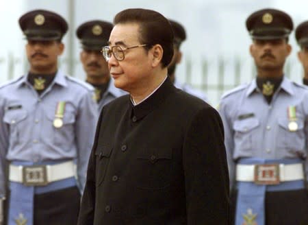 FILE PHOTO: Chairman of China's National People's Congress Li Peng inspects a military honour guard at Prime Minister hHuse in Islamabad