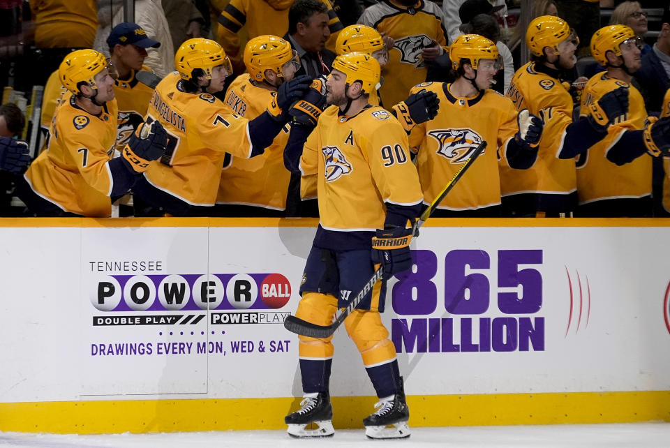 Nashville Predators center Ryan O'Reilly (90) celebrates his goal with teammates during the third period of an NHL hockey game against the Vegas Golden Knights, Tuesday, March 26, 2024, in Nashville, Tenn. The Predators won 5-4 in overtime. (AP Photo/George Walker IV)