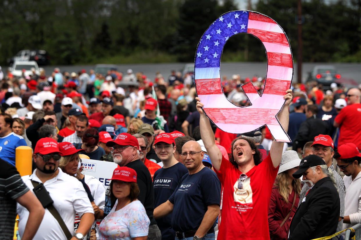 A man holds up a large "Q" sign while waiting in line to see President Donald J. Trump at his rally on Aug. 2, 2018 in Wilkes Barre, Pennsylvania. (Photo: Rick Loomis/Getty Images)